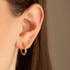 14K Two Tone Gold Striped Hoop Earrings on female model