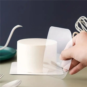 Transparent acrylic cake scrapers set showing two clear scrapers used on a buttercream cake