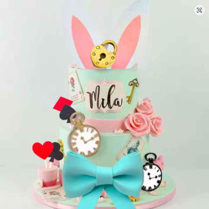 Alice in Wonderland Cake Decorating Kit, decorative cake with pink roses, clock, key, rabbit ears, and a large blue bow, for themed celebration. Alice in Wonderland Cake Decorating Kit, decorative cake with pink roses, clock, key, rabbit ears, and a large blue bow, for themed celebration.