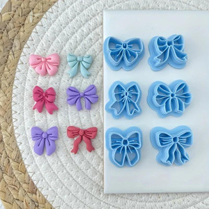 6 Piece Bow Fondant Cutter Set, set of blue fondant cutters in various bow shapes for cake decorating. 6 Piece Bow Fondant Cutter Set, set of blue fondant cutters in various bow shapes for cake decorating.