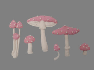 Edible Fairy Toadstool Cake Decorations Set, pink and white mushroom-shaped cake toppers on gray background. Edible Fairy Toadstool Cake Decorations Set, pink and white mushroom-shaped cake toppers on gray background.
