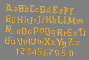 The Cake Mixer Individual Witch or Wizard Font Letters and Numbers in gold color, set on a gray background. The Cake Mixer Individual Witch or Wizard Font Letters and Numbers in gold color, set on a gray background.