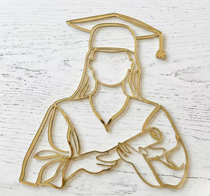 Gold mirrored acrylic graduation cake charm featuring a female graduate wearing a graduation cap and holding a diploma.