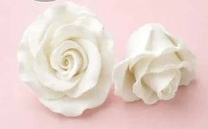 Handcrafted white gumpaste rose cake decoration measuring approximately 4.5cm x 3cm, sold individually for wedding and celebration cakes.