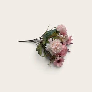 Pink artificial flower cake topper bouquet with blush roses, daisy-style flowers and green foliage
