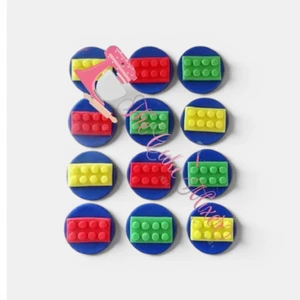 Pack of 12 Lego inspired edible cupcake toppers featuring colourful building brick designs in red, yellow, green and blue.