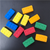 Handmade edible fondant LEGO-style bricks in assorted bright colours for decorating birthday cakes and cupcakes.