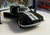 Black die cast muscle car cake topper with racing stripes