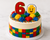 LEGO Cake Decorating Kit including edible image border, wafer paper face topper, edible number topper, sprinkles and edible building bricks for an 8 inch birthday cake.