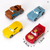Disney Cars character toy cake topper set with four colourful racing vehicles including a red race car and themed character cars