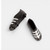 Mini black and white soccer boots cake decorations measuring approximately 3cm x 1cm for football themed cakes