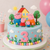 Peppa Pig Birthday Cake with Happy Birthday character topper, house, flowers, clouds and colourful garden decorations