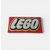 Handmade edible fondant LEGO logo plaque cake decoration in red, white, black and yellow colours.