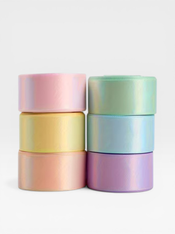 Pastel satin ribbon rolls and gift wrapping bow in soft colours