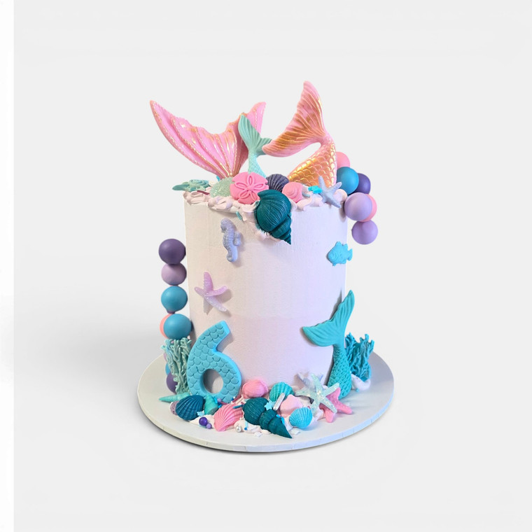 Mermaid Create the Look Cake Decorating Kit featuring pastel mermaid tails, shells, coral decorations and cake decorating supplies for creating a stunning mermaid birthday cake.