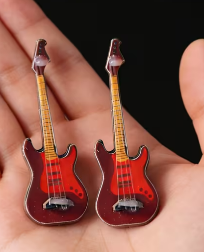 Mini red guitar cake decoration topper measuring 6.5cm, ideal for music themed birthday cakes and celebration cakes