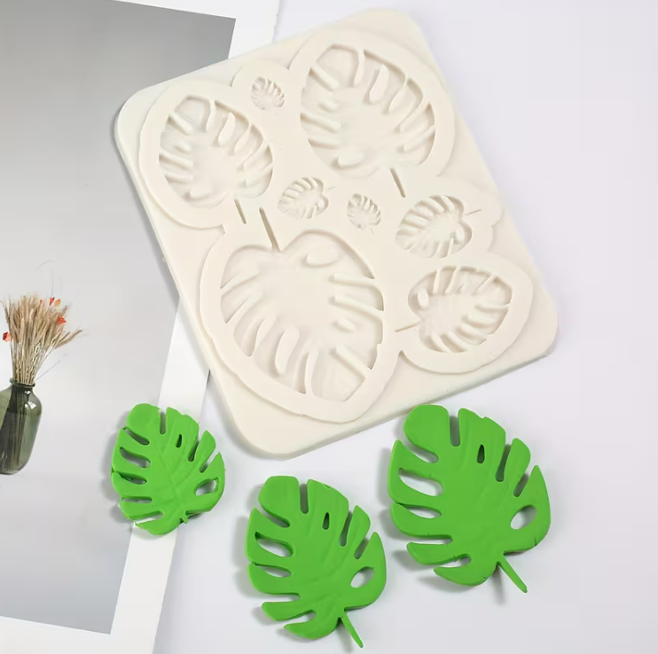 Tropical leaf silicone mould featuring monstera and palm leaf designs for fondant and cake decorating.