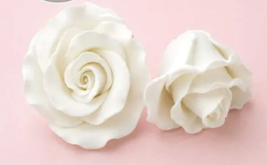 Handcrafted white gumpaste rose cake decoration measuring approximately 4.5cm x 3cm, sold individually for wedding and celebration cakes.