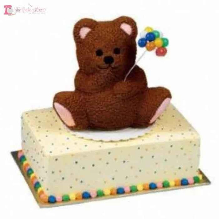 3D Teddy Bear/Panda Cake Tin Hire, adorable brown teddy bear and panda themed cake decoration on a rectangular cake with colorful dot and bead embellishments, available for collection from Howick.
