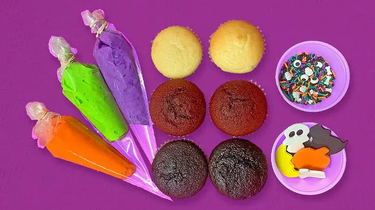 Halloween Cupcake Decorating Kit with 6 cupcakes, orange green and purple icing, sprinkles and spooky decorations