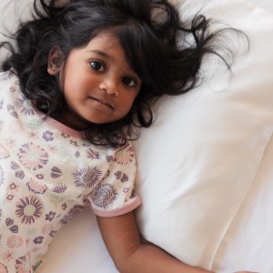 preschool girl lying on the sleep store pillow with mulberry silk pillowcase.jpg