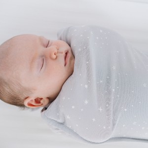 newborn baby asleep and swaddled in organic cotton fitted swaddle.jpg