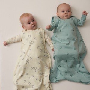 twin babies wearing the sleep store nz jersey merino sleeping bags in vanilla kisses and sage owls.jpg