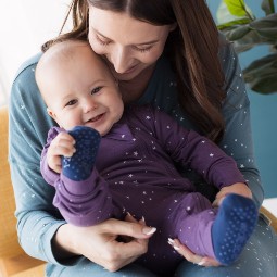 baby-sitting-on-mums-knee-both-wearing-woolbabe-merino-organic-cotton-pj-suit-in-twilight-stars-and-woolbabe-sleep-socks.jpg