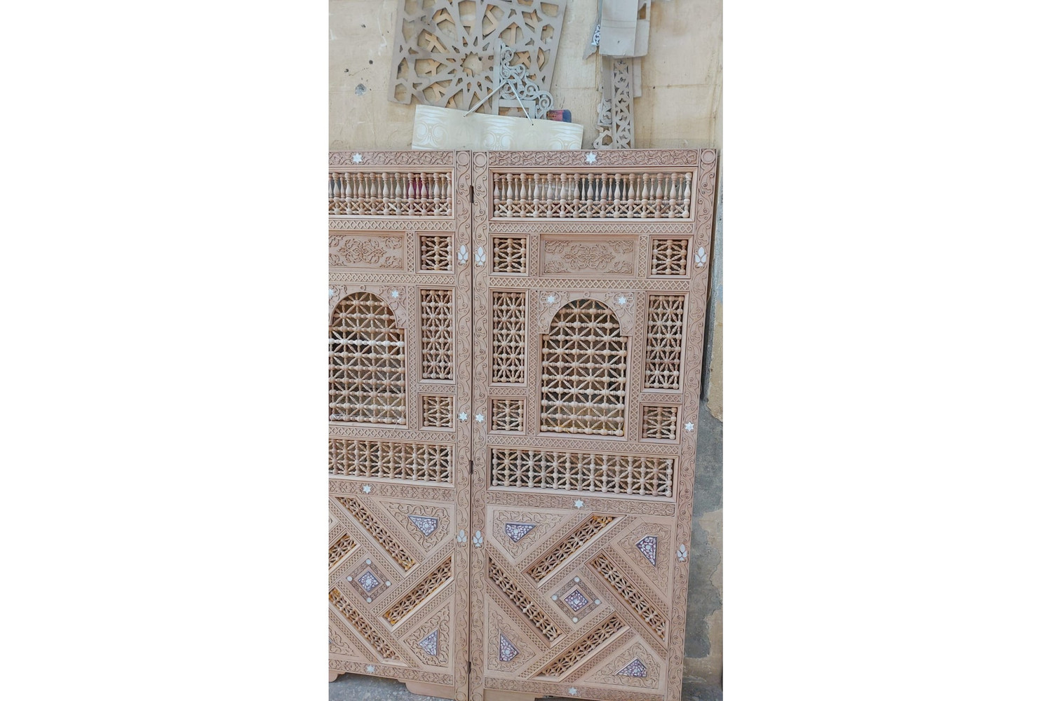 Carved wood armoire in hand-cut solid wood