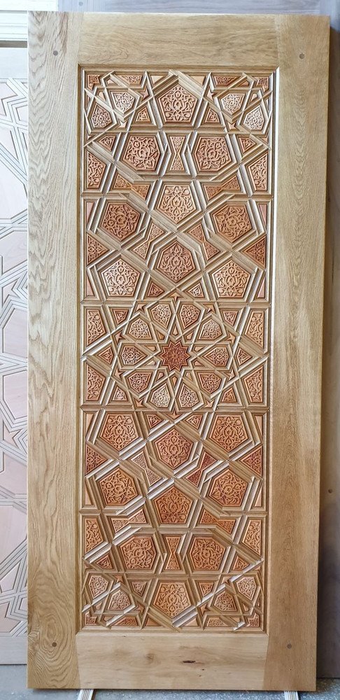 Hand-carved relief geometric door panel with star and hexagon medallions in a solid oak frame