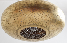 Moroccan style brass ceiling lamp in gold, artisan light fixture for living room, kitchen, or entryway, casting exotic patterns with warm bohemian charm.