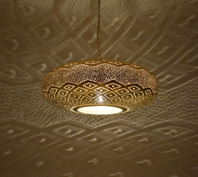 Handmade Moroccan lantern light in gold brass, casting intricate wall patterns, ideal for boho interiors, dining areas, kitchens, or entryway ceilings.