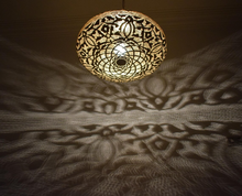 Moroccan style ceiling pendant lamp, handcrafted brass chandelier that casts intricate shadows, suitable for kitchens, dining areas, or living spaces.