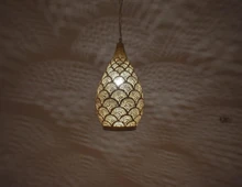 Handmade Moroccan teardrop pendant light crafted in polished brass, suspended as an elegant ceiling fixture ideal for kitchen islands or dining rooms.