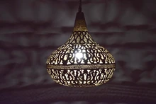 Boho Moroccan pendant lamp in durable brass, suspended from a chain to illuminate patios, porches, and outdoor living areas.