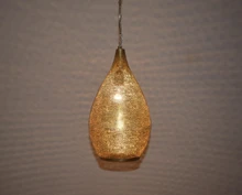 Moroccan style brass hanging light for kitchen island use, artisan-crafted with intricate cutouts, perfect for boho-inspired kitchens.