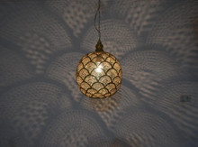 Brass Moroccan bedside chandelier pendant lamp, artisan-crafted to bring warmth and bohemian charm to bedroom lighting.