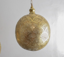 
Kitchen island lighting featuring Moroccan boho brass pendant

