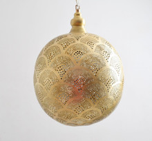 Moroccan 3-light brass pendant set illuminating dining space