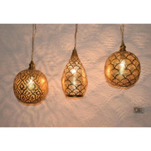 Moroccan brass pendant lights with three lamps over a kitchen island
