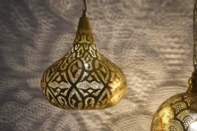 Rustic boho ceiling fixture with three Moroccan brass lamps