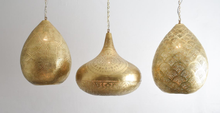 Moroccan brass pendant light cluster above a kitchen island