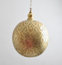 Moroccan pendant chandelier creating patterns on walls