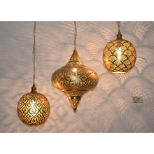 Moroccan brass pendant lamp cluster hanging in a staircase
