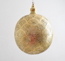 Moroccan brass cluster chandelier lighting an outdoor patio