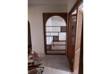 Arched wood room divider — solid wood grain and finish detail