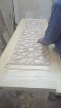 Carved mashrabiya door with solid brass handles