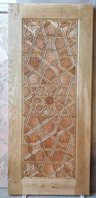Hand-carved relief geometric door panel with star and hexagon medallions in a solid oak frame