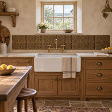 Woven Star Circle Knot in hand-embossed brass, as a backsplash band behind a farmhouse sink in a country kitchen