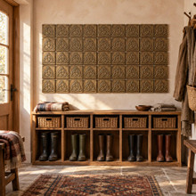 Trinity Knot with Circle Celtic knot tiles in hand-embossed brass, as a wall panel above a boot bench in an entryway mudroom